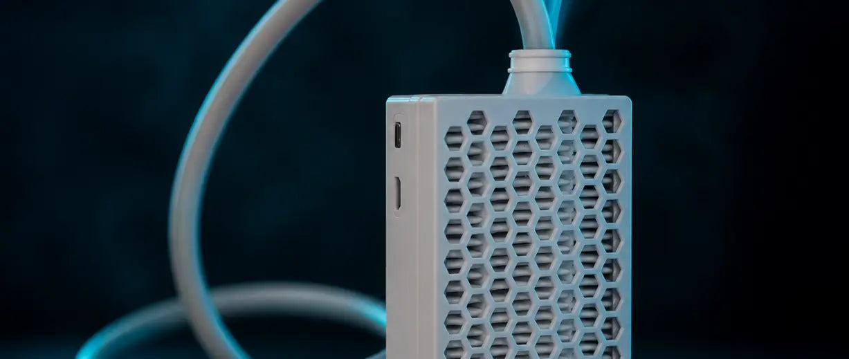 Roam Free air purifier with a honeycomb-patterned front grille and a white curved cord, shown against a dark blue background with a blue mist or vapor effect at the top.