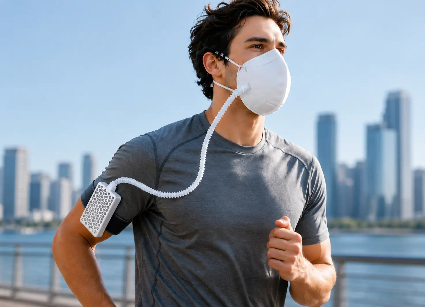 A man jogging outdoors wearing a white face mask connected to a Roam Free air purifier, with a city skyline and water in the background.
